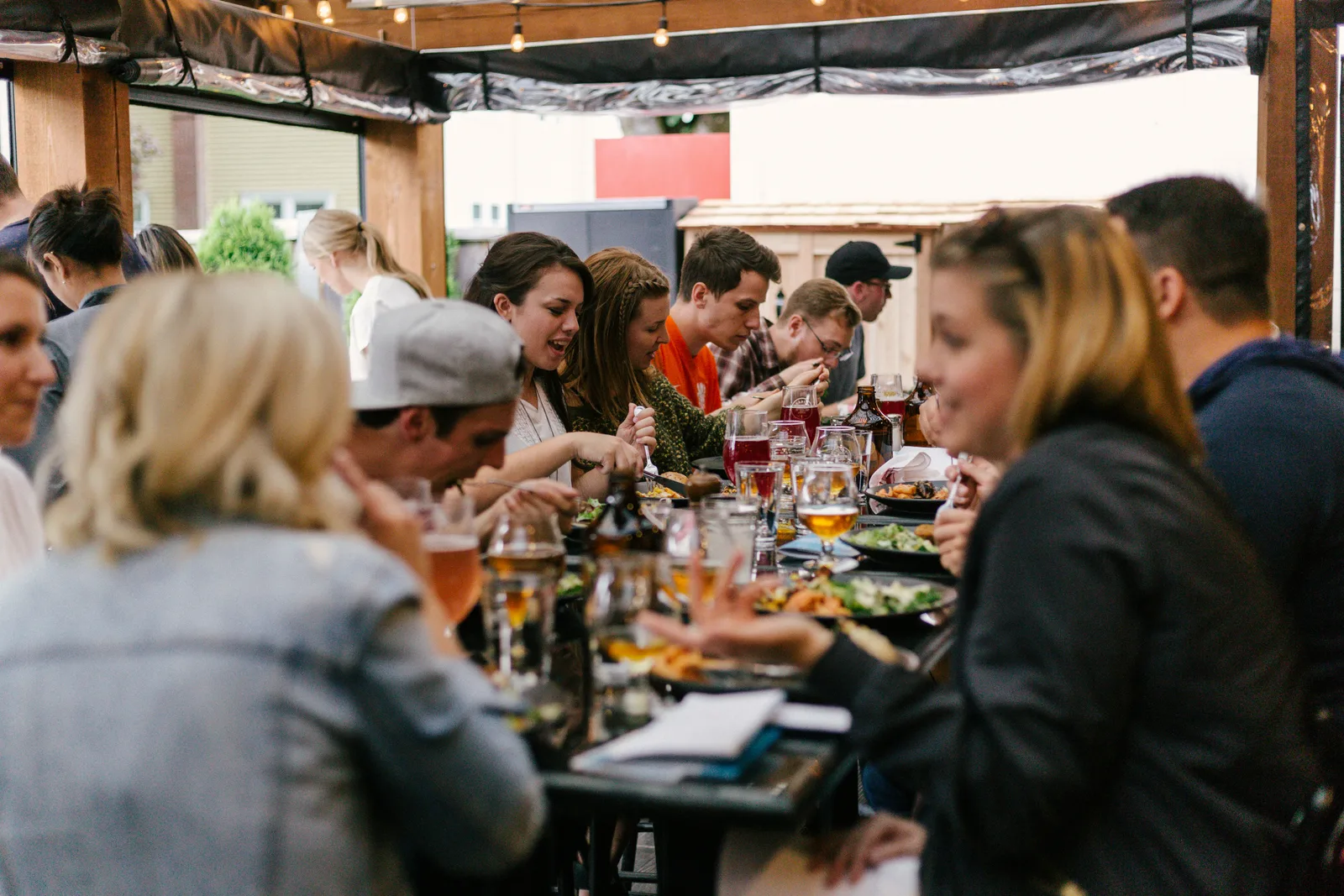Guests enjoying pizza in the warm, lively atmosphere of an Aurenza Web New York City location